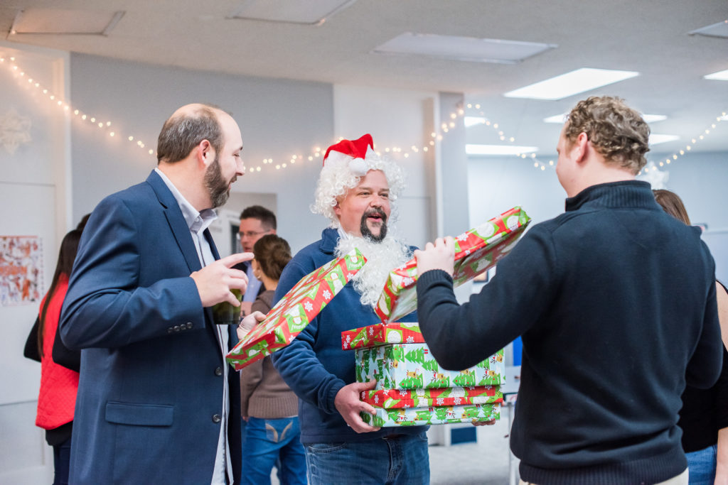 Group of man exchanging gifts